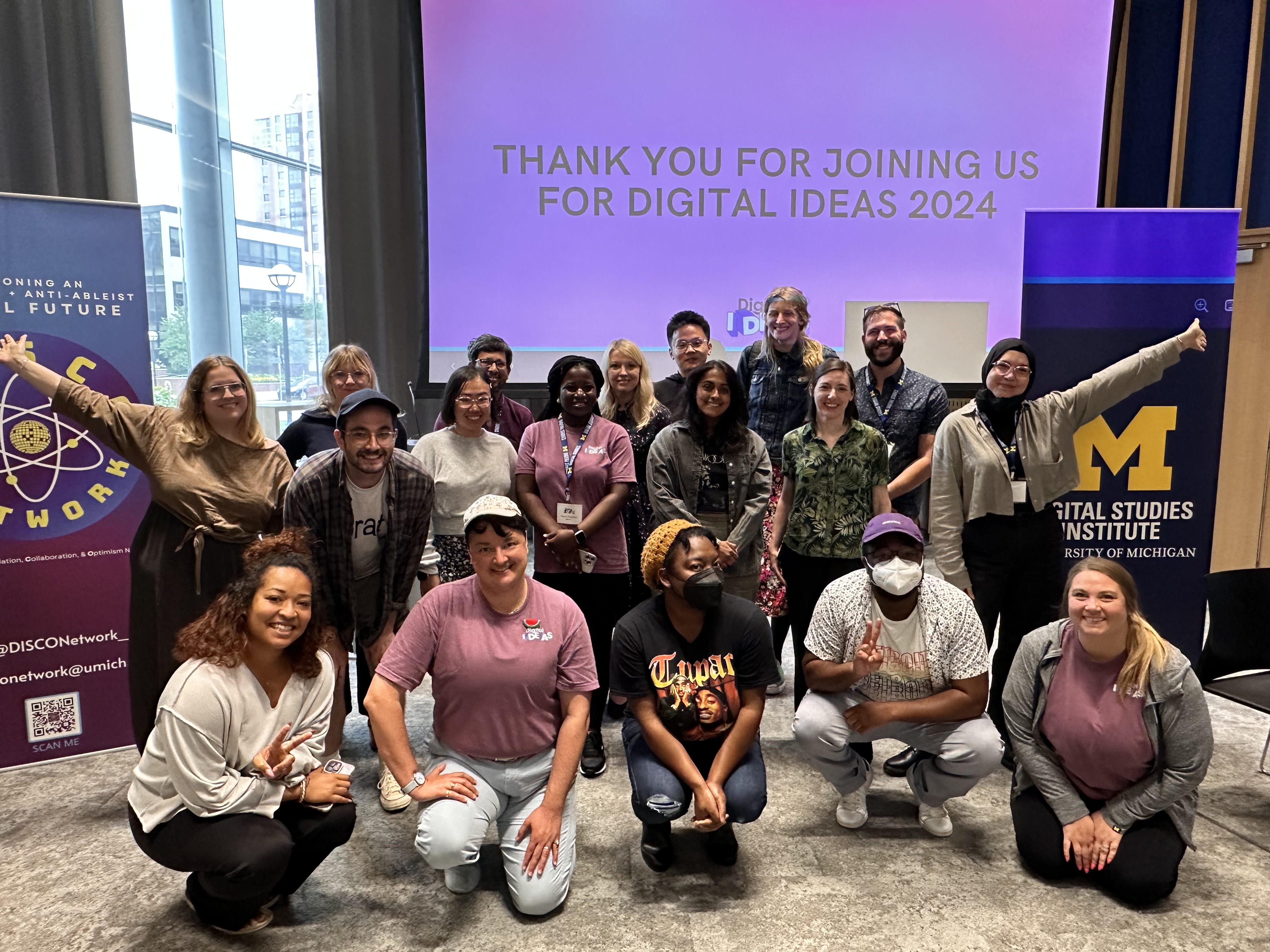 group photo of attendees to Digital IDEAS 2024 flanked by blue University of Michigan Digital Studies Institute banners